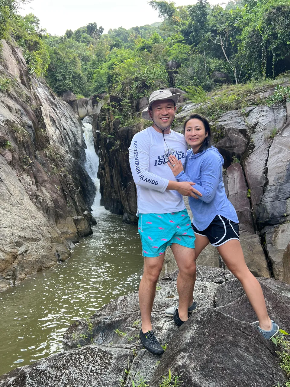 Couple on the rock ledge above the waterfall gorge at Charco El Hippie