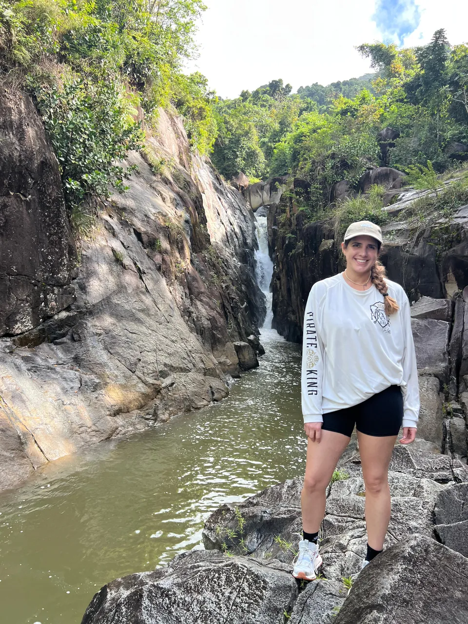 Guest standing on the boulders above the gorge pool at Charco El Hippie